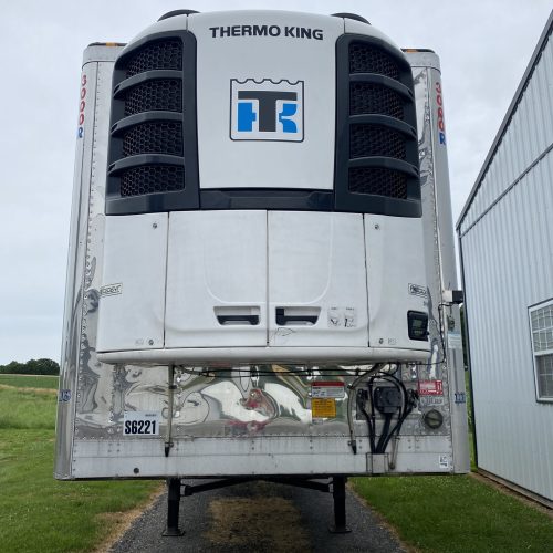 White trailer with black tank attached.