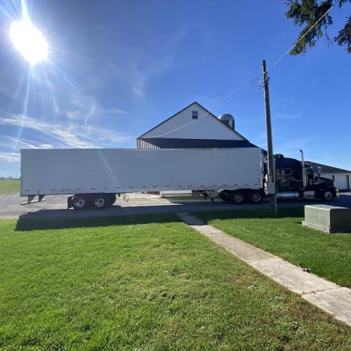 Image of a semi truck parked in front of a house.