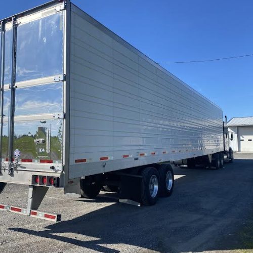 A large semi trailer parked in a lot.